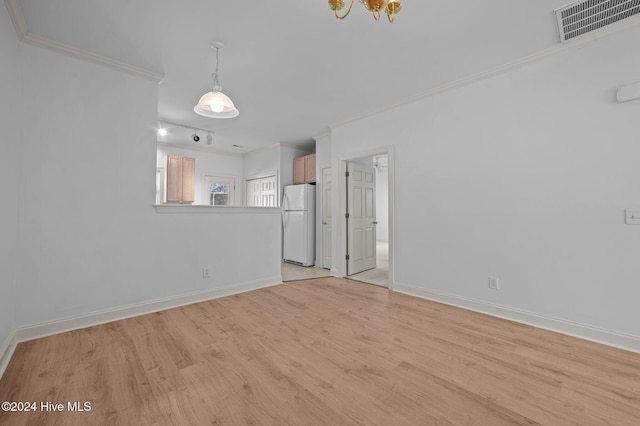 spare room with light hardwood / wood-style floors and ornamental molding