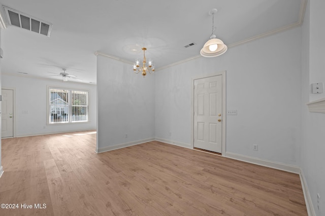 spare room featuring ceiling fan with notable chandelier, light hardwood / wood-style floors, and crown molding