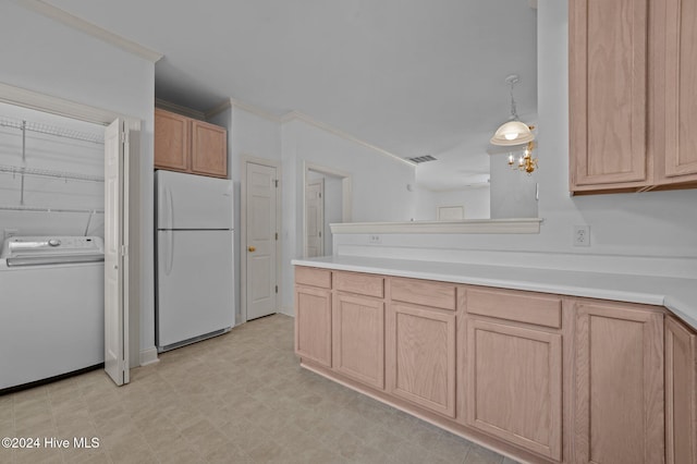 kitchen featuring washer / dryer, white fridge, and light brown cabinetry