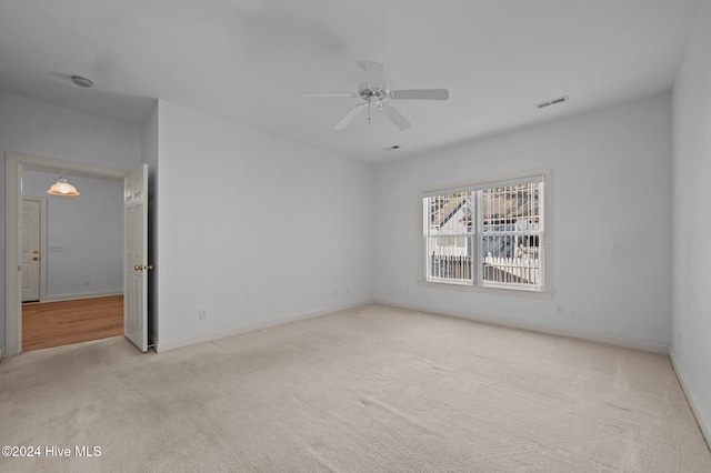 unfurnished room with ceiling fan and light colored carpet