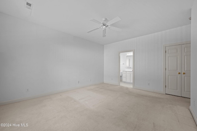 carpeted empty room featuring ceiling fan