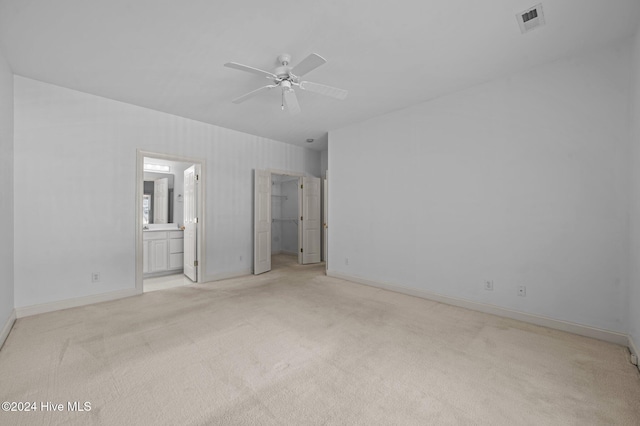 carpeted spare room with ceiling fan