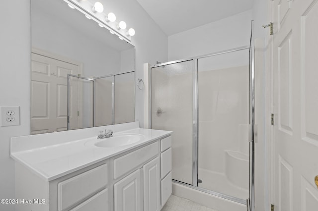 bathroom with tile patterned flooring, vanity, and an enclosed shower