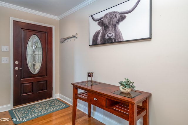 entrance foyer featuring wood-type flooring and crown molding