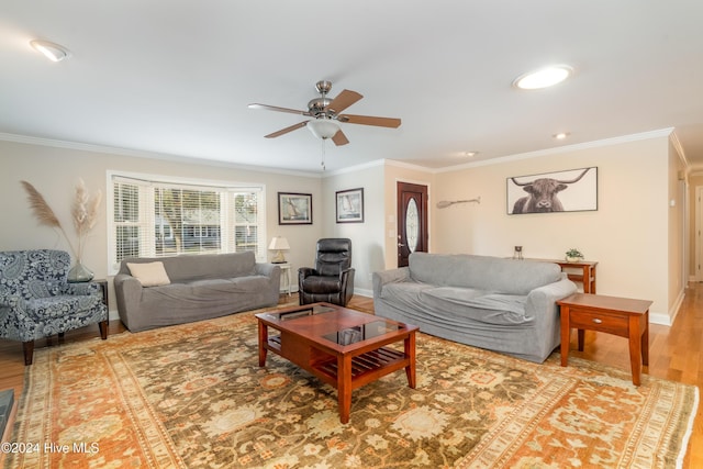 living room featuring hardwood / wood-style flooring, ceiling fan, and ornamental molding