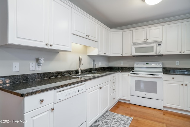 kitchen featuring white cabinets, white appliances, light hardwood / wood-style floors, and sink