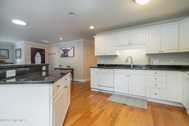 kitchen featuring dark stone counters, sink, dishwasher, white cabinets, and light hardwood / wood-style floors