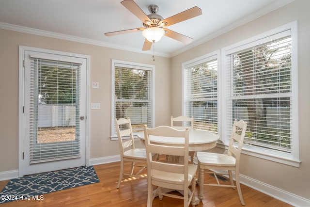 dining space featuring ceiling fan, hardwood / wood-style floors, and ornamental molding