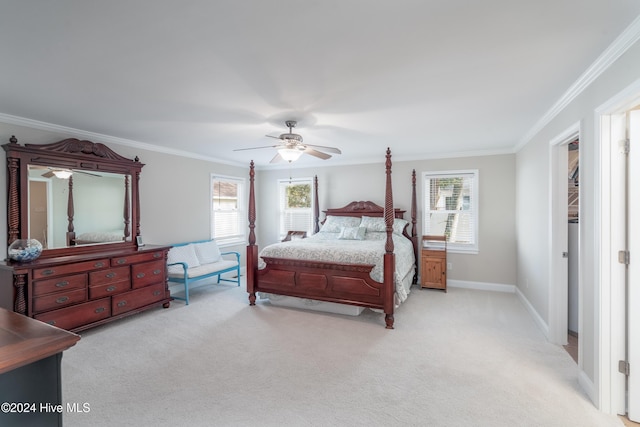 bedroom with multiple windows, ceiling fan, and light colored carpet