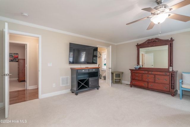 carpeted living room featuring ceiling fan and ornamental molding