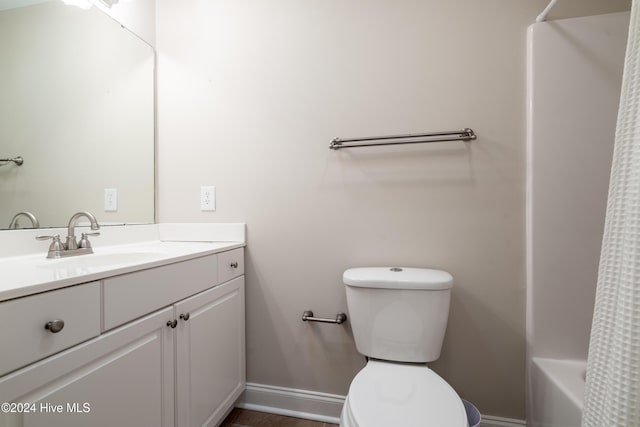 full bathroom with shower / bath combination with curtain, toilet, and vanity