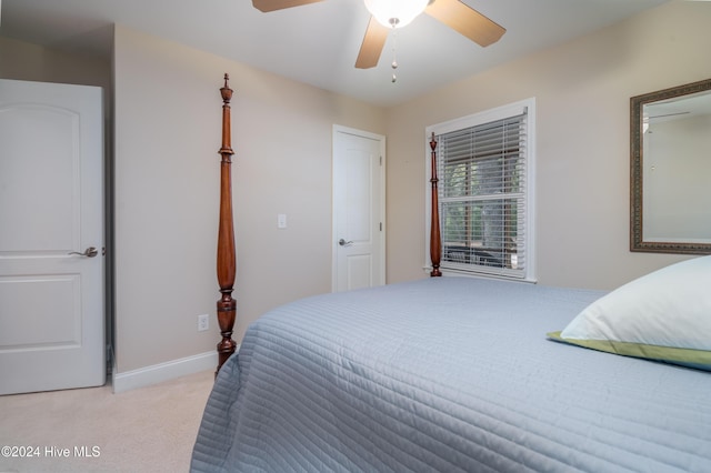 bedroom featuring ceiling fan and light carpet