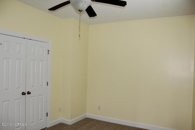 unfurnished bedroom with ceiling fan, a closet, and carpet floors