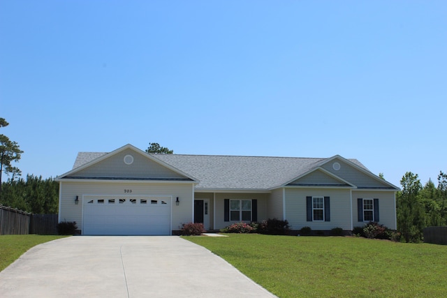 ranch-style home with a garage and a front lawn