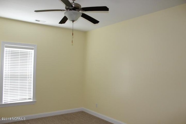 empty room featuring carpet flooring and ceiling fan