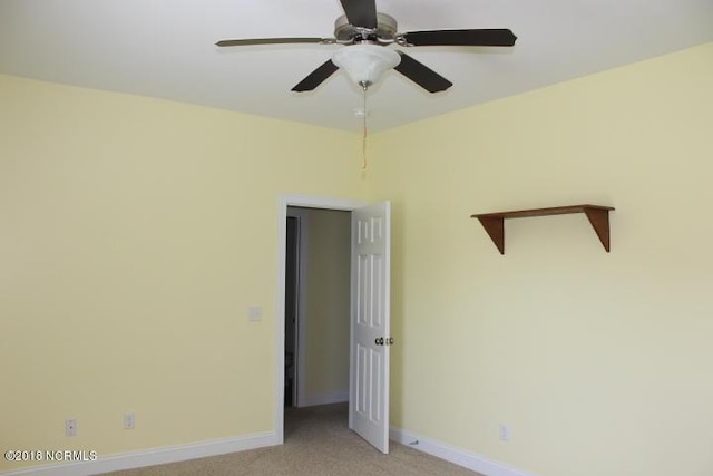 empty room with ceiling fan and light colored carpet