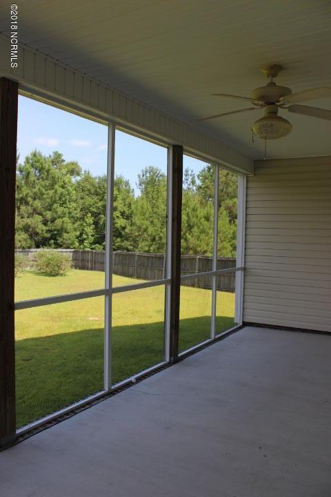 unfurnished sunroom featuring ceiling fan