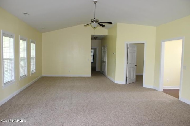 carpeted empty room with ceiling fan and vaulted ceiling