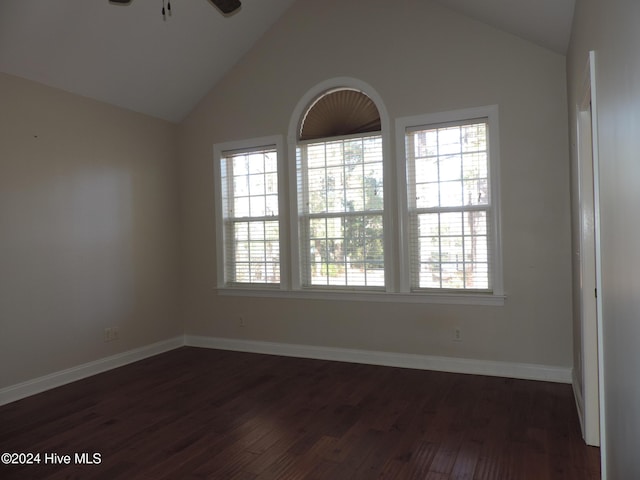 unfurnished room featuring ceiling fan, dark hardwood / wood-style flooring, high vaulted ceiling, and a healthy amount of sunlight