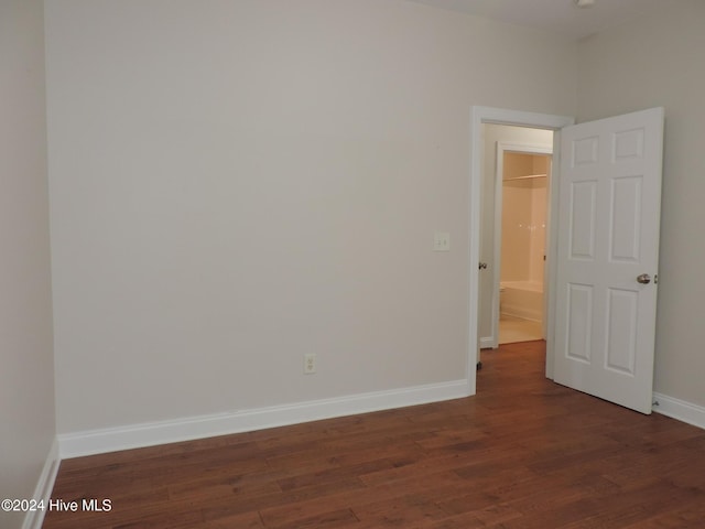 empty room featuring dark wood-type flooring