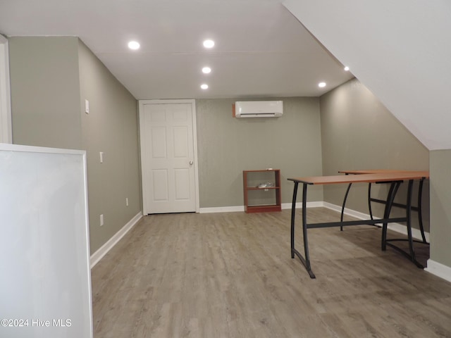 interior space with a wall mounted AC and light wood-type flooring