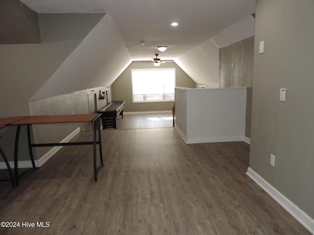 bonus room with ceiling fan, dark hardwood / wood-style flooring, and vaulted ceiling