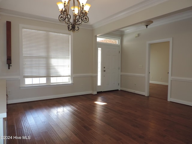 entryway featuring a chandelier, dark hardwood / wood-style flooring, and ornamental molding