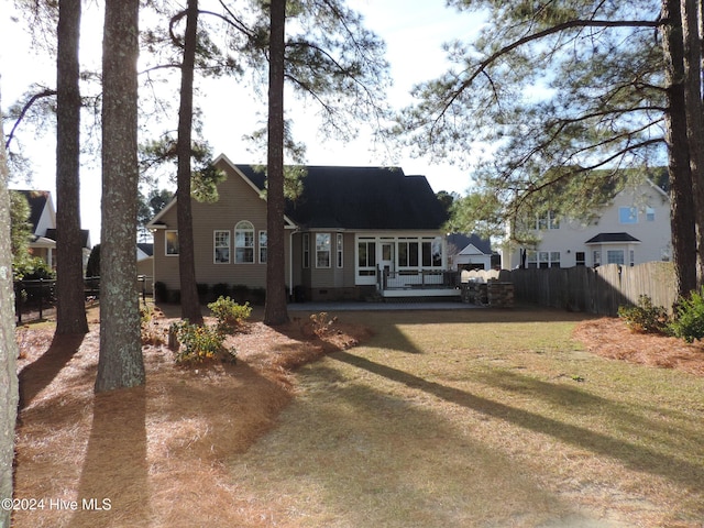 rear view of house featuring a yard