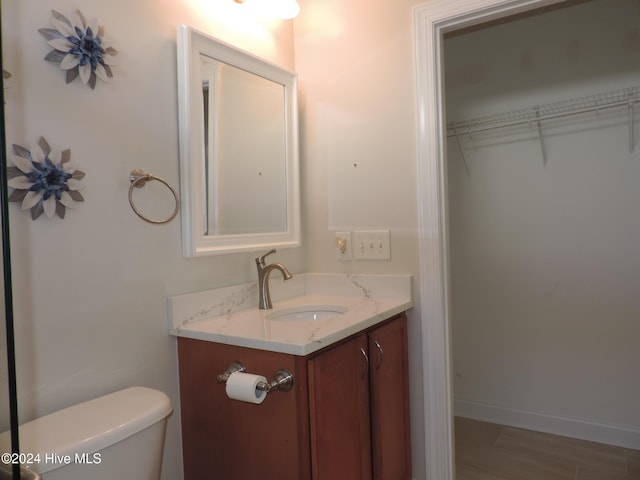 bathroom featuring hardwood / wood-style flooring, vanity, and toilet