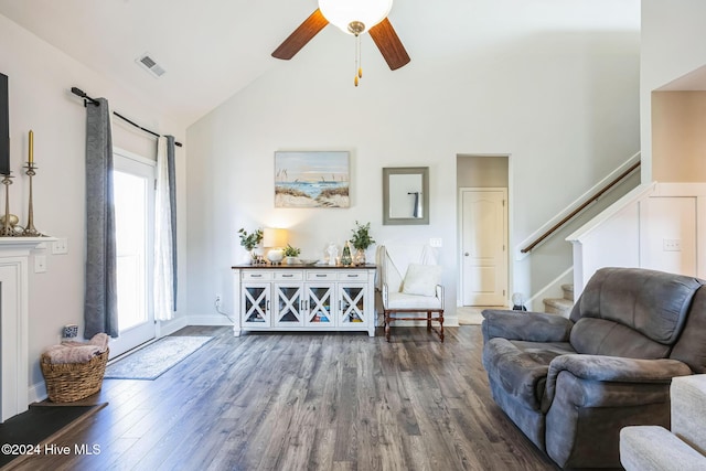 living room with dark hardwood / wood-style flooring, high vaulted ceiling, and ceiling fan