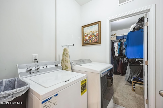 laundry room featuring light carpet and independent washer and dryer