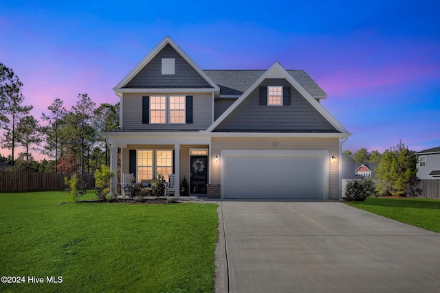 craftsman-style house with a yard and a garage