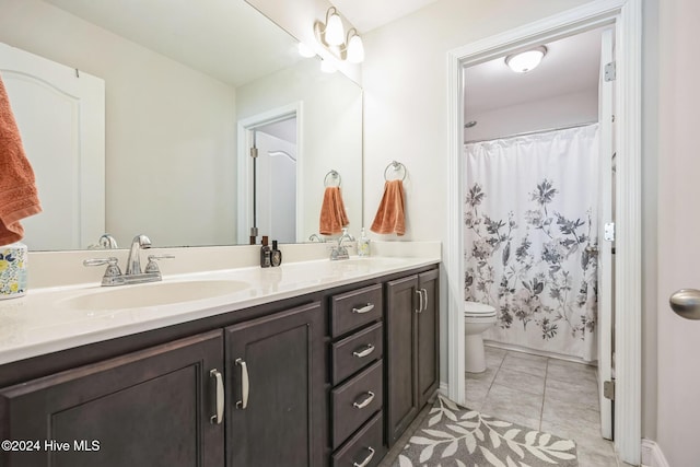 bathroom with toilet, a shower with curtain, vanity, and tile patterned floors