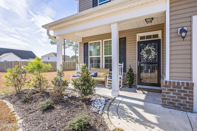 doorway to property featuring covered porch