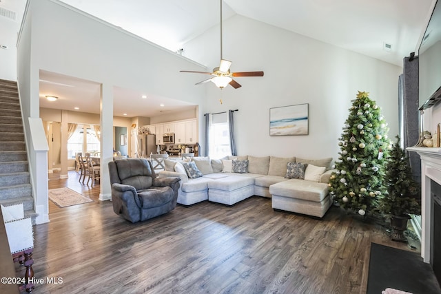 living room with dark hardwood / wood-style floors, high vaulted ceiling, and ceiling fan