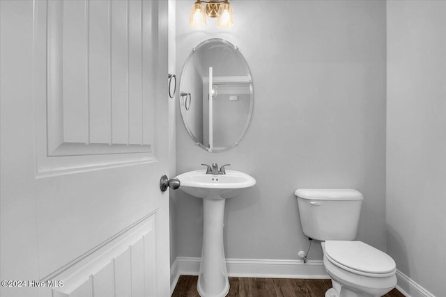 bathroom featuring hardwood / wood-style floors, toilet, and sink