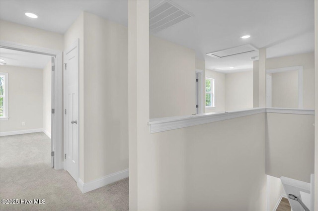 hallway with baseboards, visible vents, recessed lighting, and carpet flooring