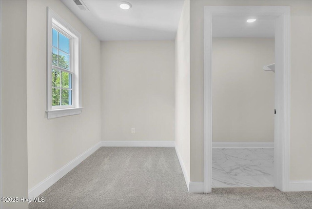 interior space with carpet, visible vents, and baseboards