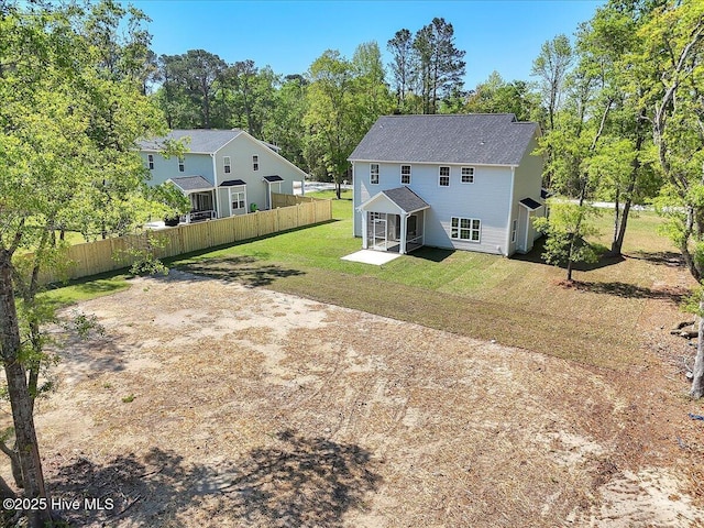 back of house with fence, a lawn, and a patio