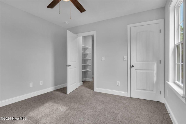 unfurnished bedroom featuring ceiling fan and carpet floors