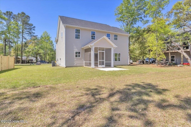 back of house with central AC unit, a sunroom, and a yard