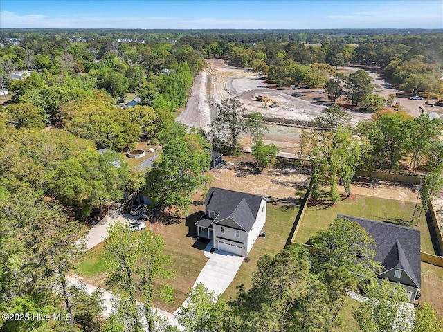 aerial view featuring a wooded view