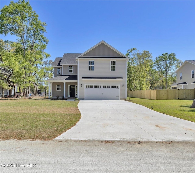 view of front of home with fence, an attached garage, driveway, and a front yard
