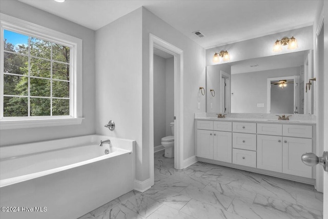 bathroom with a bath, vanity, and toilet