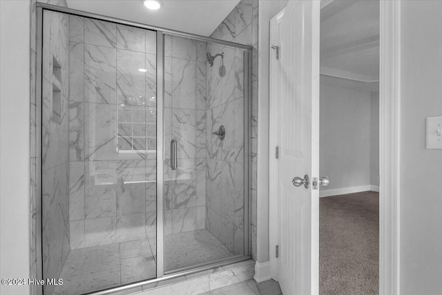 bathroom with a shower with shower door