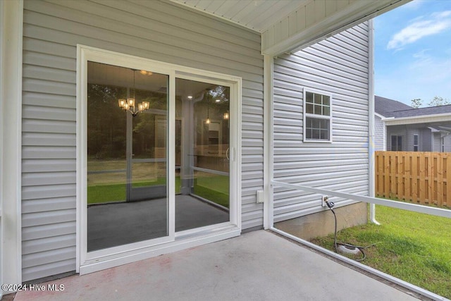 view of exterior entry with a patio area