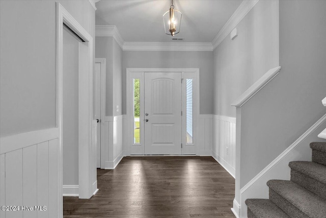 foyer featuring dark hardwood / wood-style floors and crown molding