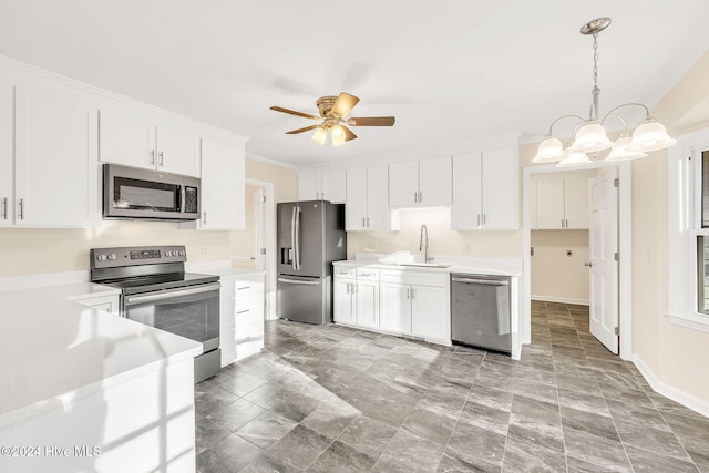 kitchen with white cabinetry, sink, stainless steel appliances, pendant lighting, and ceiling fan with notable chandelier