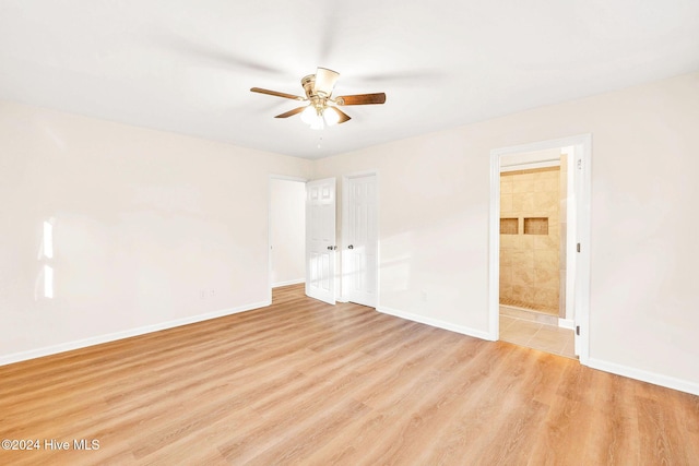 empty room featuring light wood-type flooring and ceiling fan