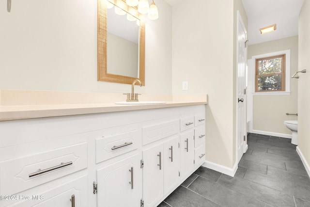 bathroom featuring tile patterned floors, vanity, and toilet